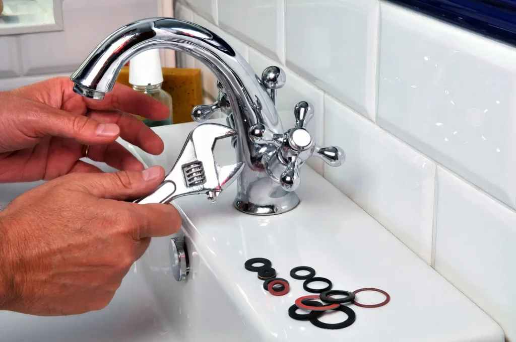 Plumber performing maintenance on a bathroom faucet in Santa Cruz