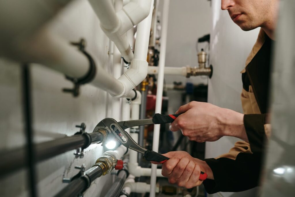 Plumbers maintaining commercial plumbing pipes in Santa Cruz