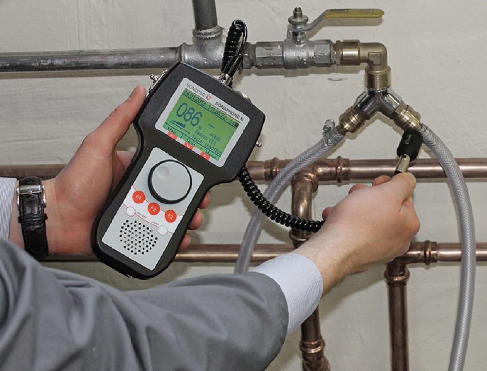 Plumber testing pipes with electronic leak detection equipment in Santa Cruz