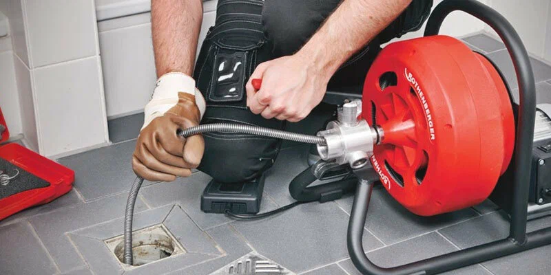 Plumber using a drain-cleaning machine in Santa Cruz