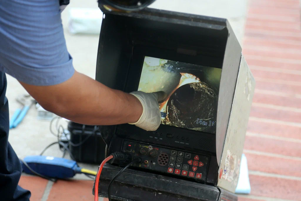 Technician viewing a drain inspection camera in Santa Cruz
