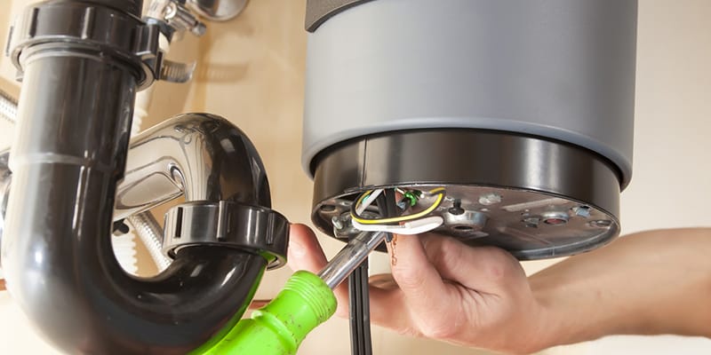 Technician repairing the heating element of a water heater in Santa Cruz