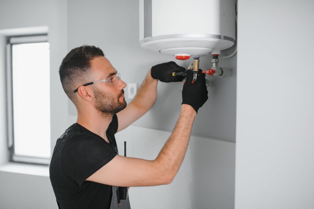 Technician performing water heater maintenance in Santa Cruz