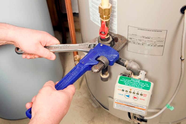 Plumber repairing a water heater valve in Santa Cruz